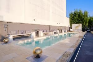 a large swimming pool with chairs in a building at Maison boutique At Pietro in San Pietro in Lama