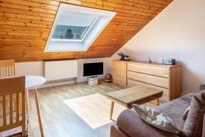 a living room with a roof with a skylight at Fewo Cheny 2 mit 36qm in Titisee-Neustadt