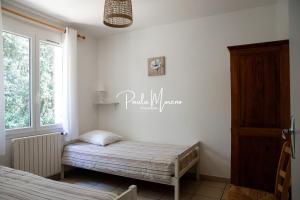 a small bedroom with a bed and a window at Gite Domaine Viticole, Pellerin in Montbrison-sur-Lez