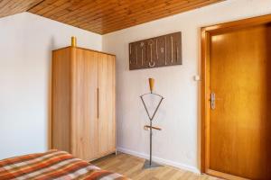 a bedroom with a bed and a wooden door at Fewo Cheny 2 mit 36qm in Titisee-Neustadt