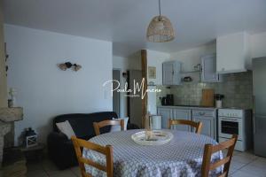 a kitchen and dining room with a table and chairs at Gite Domaine Viticole, Pellerin in Montbrison-sur-Lez