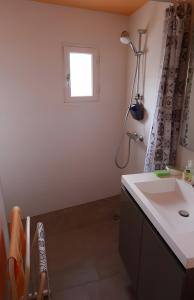 a bathroom with a sink and a window at Gîte Chez Claudette in Briord