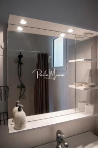 a mirror above a sink in a bathroom at Gite Domaine Viticole, Pellerin in Montbrison-sur-Lez +14 photos