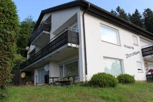 a large white building with a balcony on the side at Tannenblick in Schönwald
