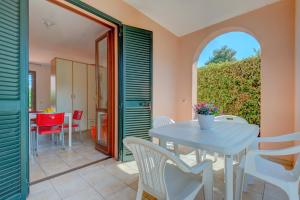 a dining room with a table and chairs at Il Sarago in Marina di Campo +12 photos