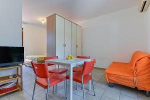 a dining room with a table and red chairs at Il Sarago in Marina di Campo