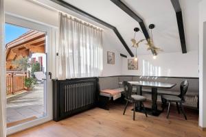 a dining room with a table and chairs and a window at Residence Skutial Santner Deluxe in Castelrotto