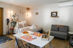 a living room with a table and a couch at Chez Flo - clim parking - clg in Saint-Pierre-dʼAlbigny