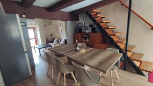 a dining room with a table and chairs and a staircase at Gnazzano Home in Loiano
