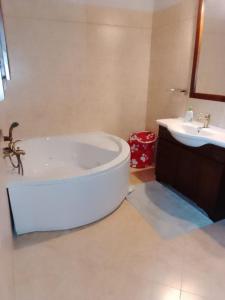 a bathroom with a bath tub and a sink at Gnazzano Home in Loiano +34 photos