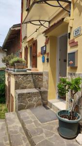 a building with a potted plant in front of it at Gnazzano Home in Loiano
