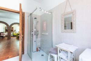 a bathroom with a shower and a table at Casa San Francesco Rapolano in Rapolano Terme +18 photos