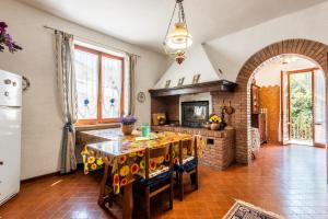 a kitchen with a table and a fireplace at Casa San Francesco Rapolano in Rapolano Terme