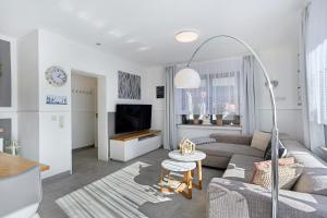 a living room with a couch and a tv at Ferienwohnung Riekes in Schmallenberg