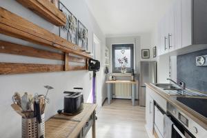 a kitchen with white cabinets and a counter top at Ferienwohnung Riekes in Schmallenberg +31 photos