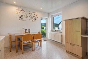 a kitchen and dining room with a table and chairs at Schöner Ith Blick in Salzhemmendorf