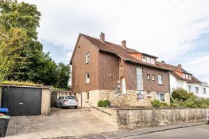 an old brick house with a car parked in the driveway at Schöner Ith Blick in Salzhemmendorf