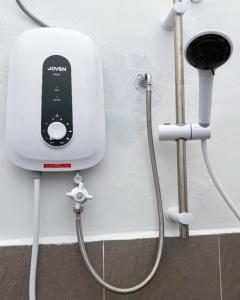 a cell phone is hooked up to a wall at Kanvas 21 in Jerantut