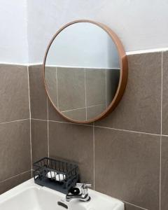 a bathroom with a mirror above a sink at Kanvas 21 in Jerantut