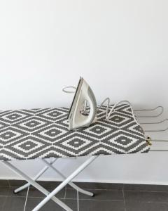a white bed with a black and white patterned blanket at Kanvas 21 in Jerantut +7 photos