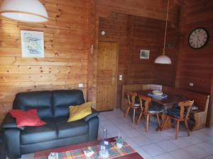 a living room with a couch and a table at Chalet paisible à Mauroux in Mauroux