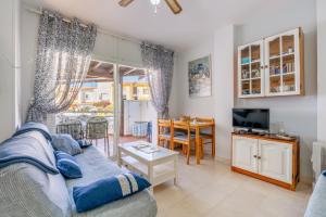 a living room with a couch and a tv and a table at Brisa y Mar in Calahonda