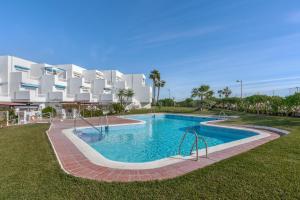 a swimming pool in front of a large building at Brisa y Mar in Calahonda