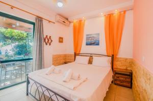a bedroom with a bed with two pillows on it at Family apartment in Corfu +15 photos