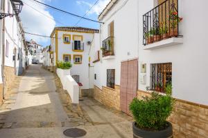 an alley in a town with white and yellow houses at La Casa De Eva in Gaucín