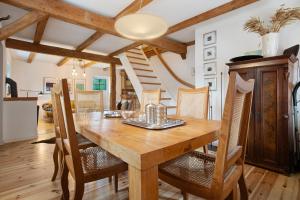 a dining room with a wooden table and chairs at Peene Hus in Hohen Demzin