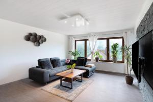 a living room with a couch and a table at Haus Erika Ferienwohnung 1 in Bad Teinach-Zavelstein