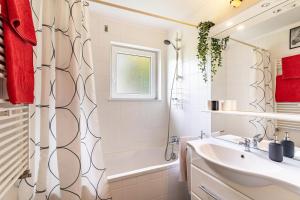 a bathroom with a sink and a tub and a shower at Ferienwohnung Am Paradies in Baden-Baden +15 photos