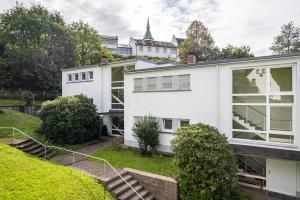an exterior view of a white house at Ferienwohnung Am Paradies in Baden-Baden