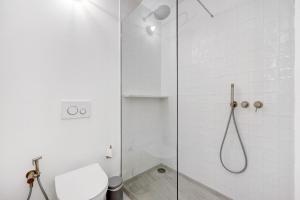 a bathroom with a glass shower with a toilet at Casa da Praia in Praia de Odeceixe +12 photos
