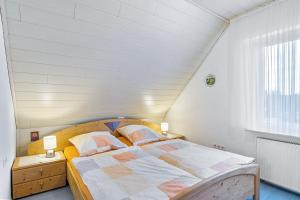 a bedroom with a large bed in a attic at Ferienhaus Knappstein in Möhnesee