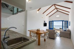 a kitchen with a sink and a table at Los Morros in Punta Mujeres +22 photos