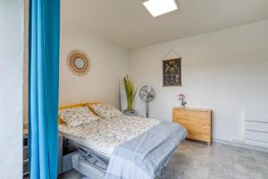 a bedroom with a bed and a dresser and a mirror at Le Cosy à la grande pyramide in La Grande Motte