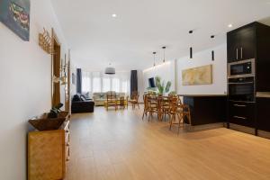 a living room with a kitchen and a dining room at Falco 1 in Corralejo
