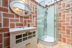 a bathroom with a sink and a shower in a brick wall at Apartamento con Encanto C in Montroig +20 photos