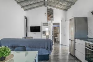 a room with a bed and a tv and a kitchen at Casa El Elefante in La Muela