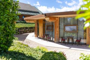 a house with a patio with chairs and a table at Albchalet in Rosenfeld +133 photos
