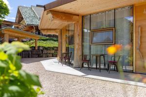 a patio with chairs and a table and a tv on a house at Albchalet in Rosenfeld
