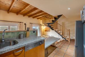 a kitchen with a sink and a staircase at Le Chalet Sierra Nevada in Monachil