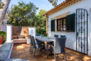 an outdoor patio with a table and chairs at Can Domingo in Pollença