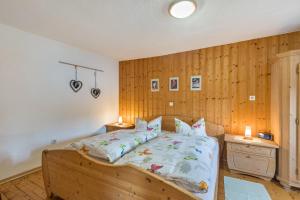 a bedroom with a bed and a wooden wall at Feriewohnung Hirtenhaus in Attendorn