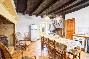 a kitchen and dining room with a table and chairs at Gite La Bessede - Dordogne in La Chapelle-Aubareil