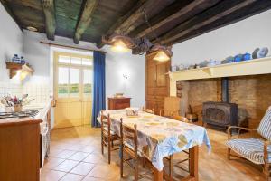a kitchen and dining room with a table and a stove at Gite La Bessede - Dordogne in La Chapelle-Aubareil +22 photos