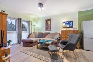 a living room with a couch and a refrigerator at Apartment On The Upper Floor in Bokelrehm