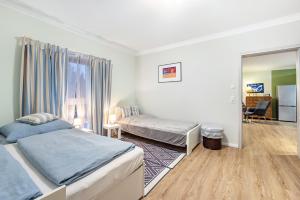 a bedroom with two beds and a mirror at Apartment On The Upper Floor in Bokelrehm