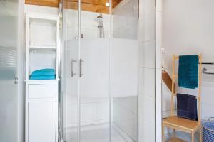 a shower with a glass door in a bathroom at Ferien im Fachwerk in Bermatingen +17 photos